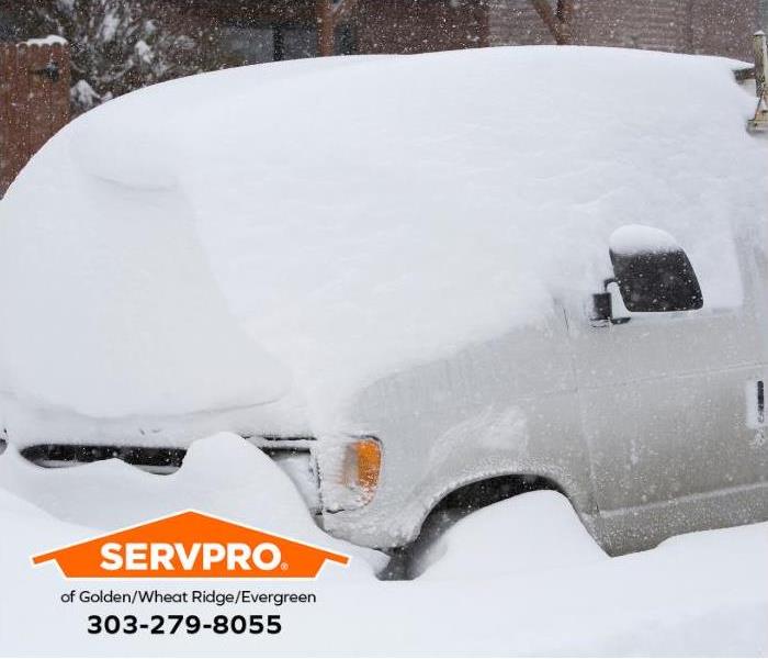 A car is covered by deep snow.
